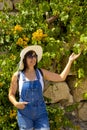 beautiful young woman in white hat and sungÃÅ¸lasses in the garden Royalty Free Stock Photo